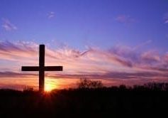 cross Silhouette of a cross against a vibrant sunrise sky, symbolizing the Love of the King.